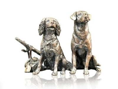 The sculpture Waiting for the Guns by Richard Cooper, a bronze of two dogs waiting expectantly